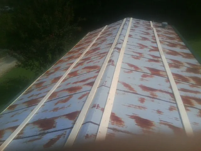 Rusted metal roof panels with new wood purlins before replacement — Storm Damage Roof Repair in Olar by Roofing Brothers